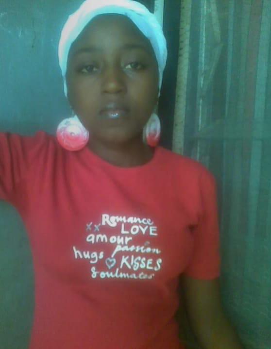 Lilian posing in a red shirt