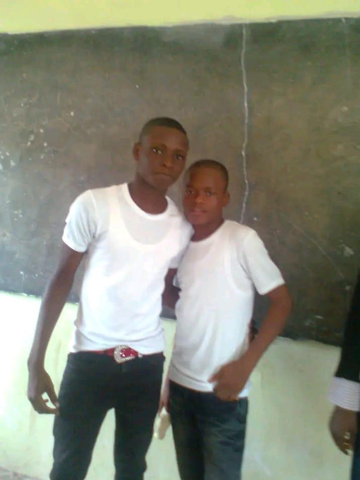 Two classmates in white shirts posing